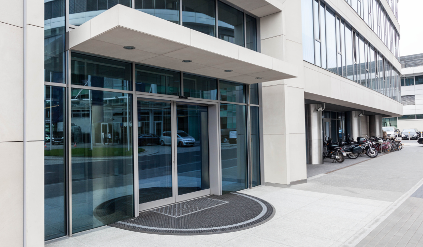 A private equity firm building with a spacious glass door, offering a glimpse of professionalism and transparency.